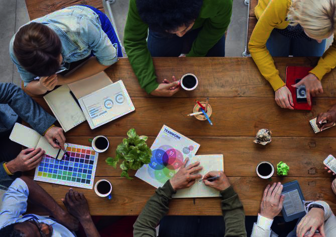 Desk covered with resources useful for development of strategic marketing communications